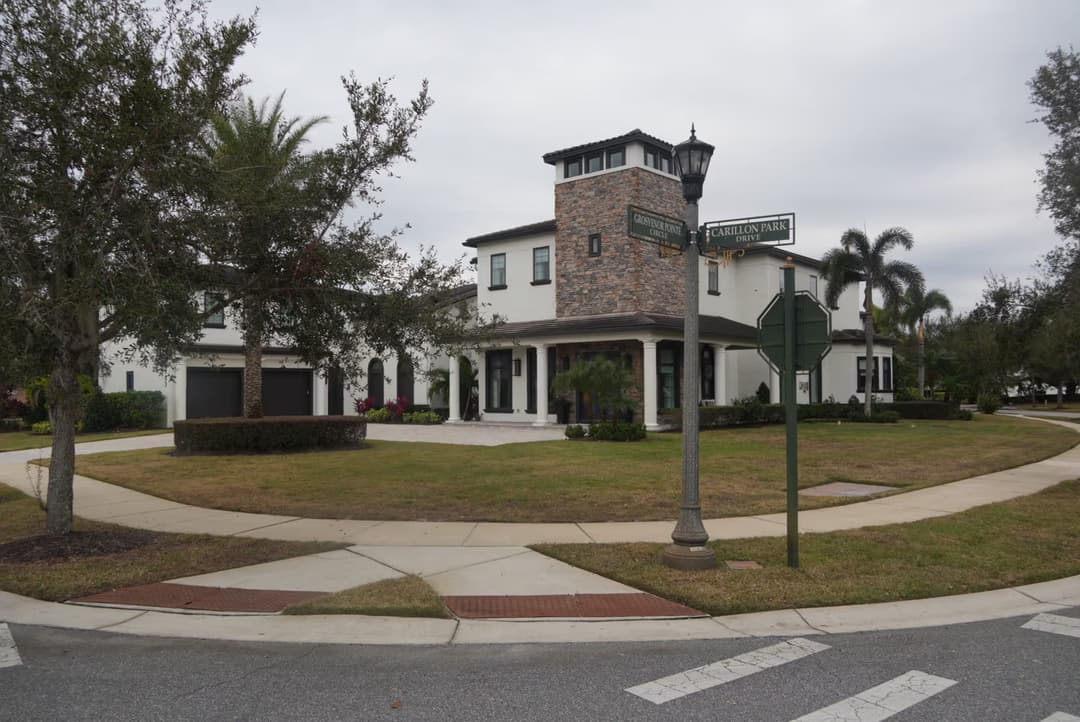 Modern home with stone accents in a landscaped roundabout near Carillion Park.