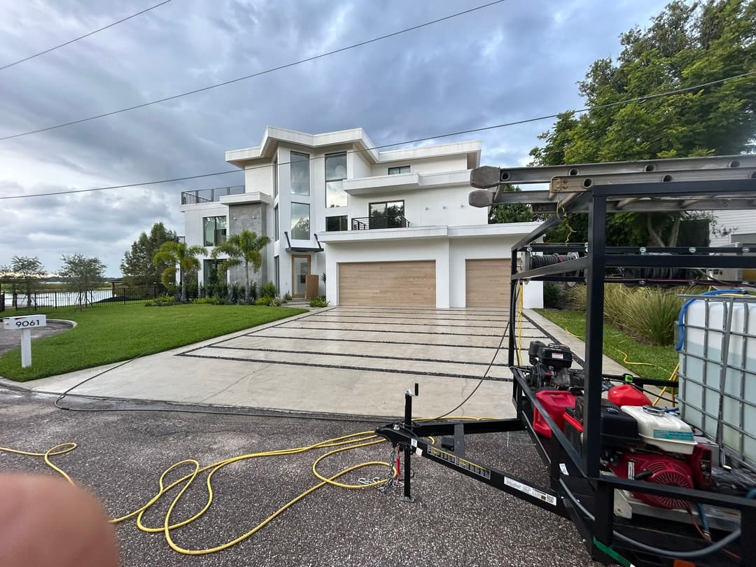 Modern luxury home with double garage, landscaped yard, and driveway in serene setting.